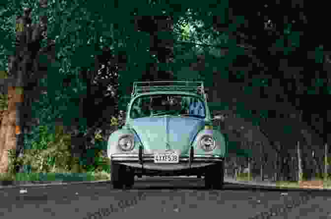 A VW Beetle Driving Down A Road VW Beetle: The Car Of The 20th Century